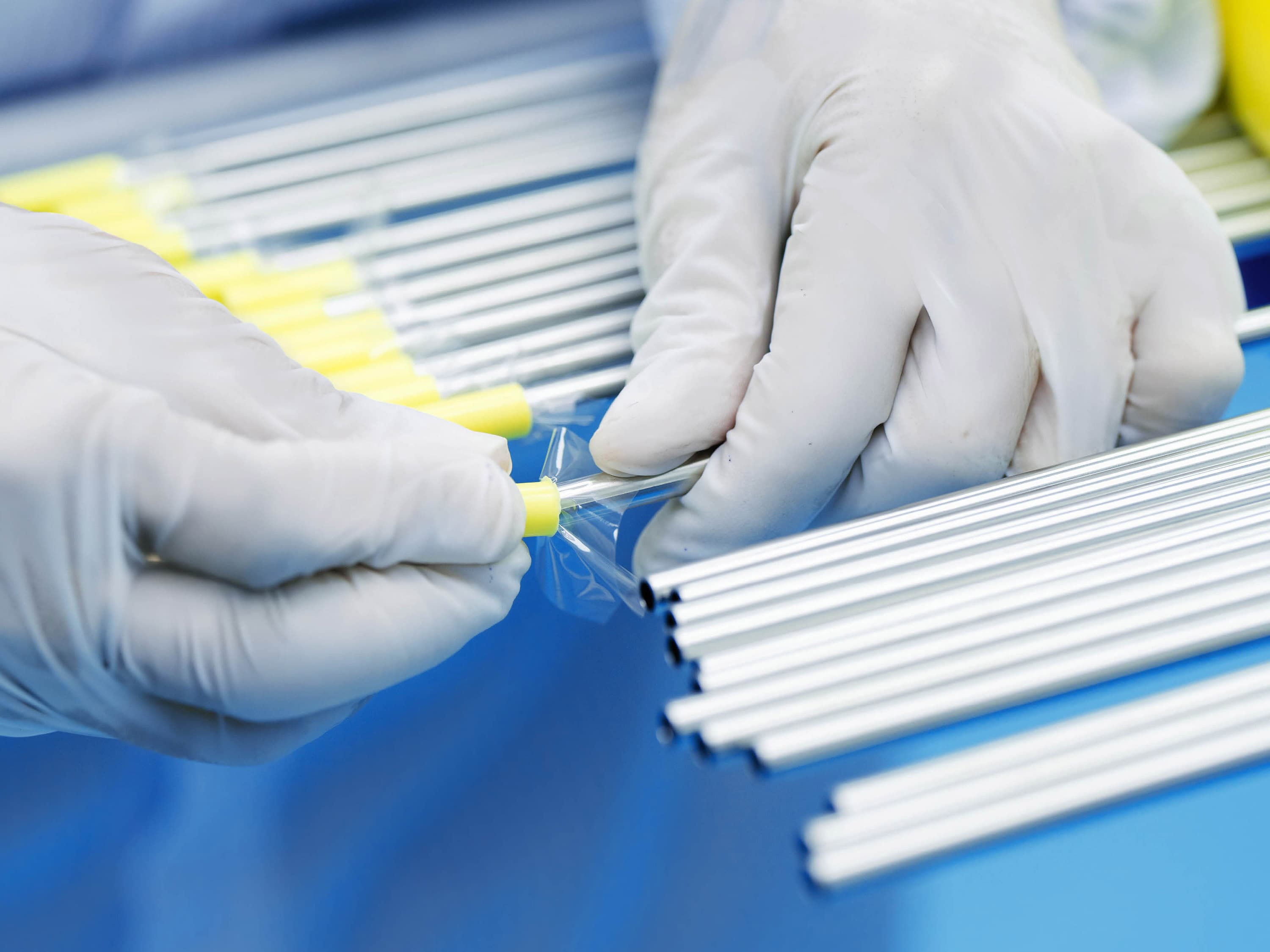 Hands in white gloves cap cleaned tubes