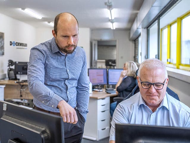 Employees of Dockweiler UK in an office situation